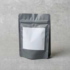 A gray standup pouch with a white label on a gray surface, isolated on white background