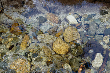 Top view of a clear mountain stream. Free-flowing river ecosystem. Gravel bars.