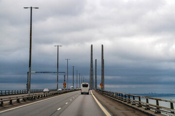 Oresund Bridge traffic crossing the strait between Copenhagen and Malmo on an overcast day, modern cable stayed highway connection. 