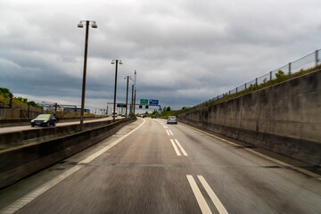 Highway leading to the Oresund Fixed Link. Cars driving on the multi lane road under a cloudy sky, representing travel and infrastructure.