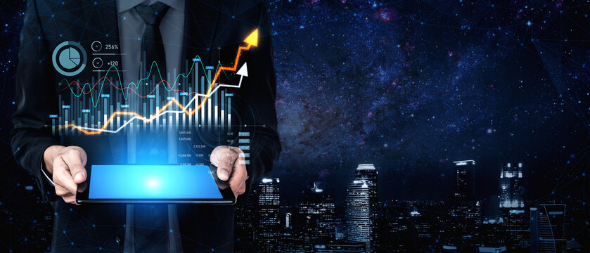 A businessman stands in a modern cityscape, holding a tablet that displays dynamic data analytics, symbolizing financial growth and success in the digital age. Scalp