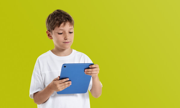 Curious child using digital gadget for internet browsing and lea