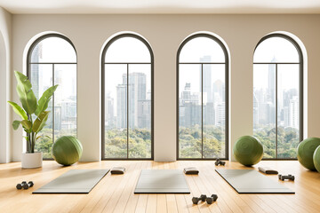 Fototapeta premium Modern yoga studio interior with arched windows, wooden floor and city view, fitness mats and green exercise balls arranged in minimalist design. 3D Rendering