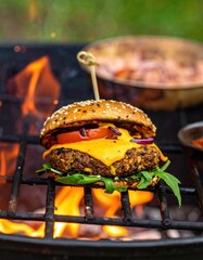 Close-up of a burger cooking over a grill with flames