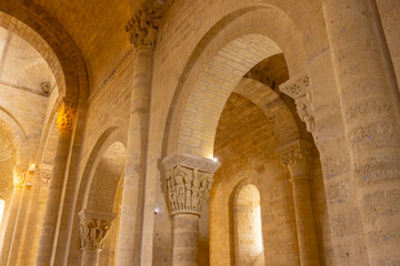 Fototapeta premium Romanesque church interior with carved capitals and stone arches in Fromista
