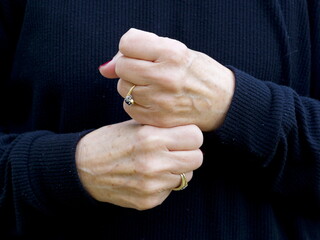 A pair of hands signing the consonant letter 'G' in British Sign Language.BSL.Communication.Hearing Impaired.