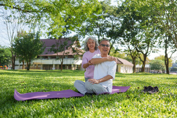 Happy asian senior couple doing yoga and stretching in park. healthy lifestyle for outdoor activity and enjoying peaceful retirement
