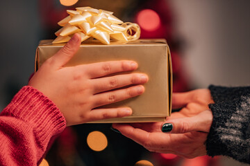 hands giving gifts at christmas with family