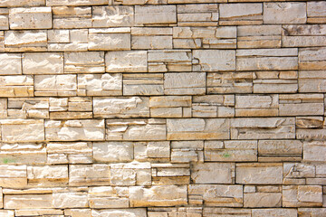 Natural stone wall texture with rough surface and horizontal brick pattern. Perfect for architecture, construction materials, and decorative background design.