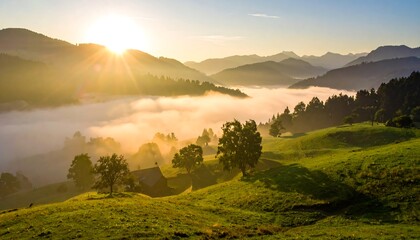 Sunburst over a rolling green landscape with distant hills shrouded in mist under a clear blue sky at sunrise