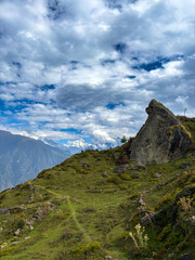 Rugged High-Altitude Hiking Trail Leading Past a Distinctive Rock Formation in Auli, Uttarakhand.