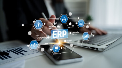 A focused business professional engages with ERP software to enhance organizational productivity....