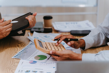 Close up of businessman using calculator to calculate financial data, check financial information,...
