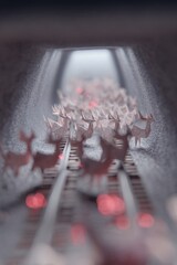 Origami reindeers flying through a snowy train tunnel