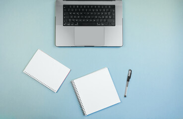 structured study setup, tidy workspace with focused tools, arranged laptops and notebooks for effective studying, neatly organized study environment with bright background and writing