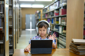 Photo set Asian little girl learning on tablet in library, smiling happiness