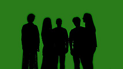 Black silhouettes of a group of people stand together against a green chroma key background. Minimalist contrast and modern visual composition, mockup.