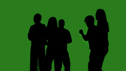 Black isolated silhouettes of people dancing cheerfully on a green chroma key background. Minimalist contrast and modern visual composition, mockup.