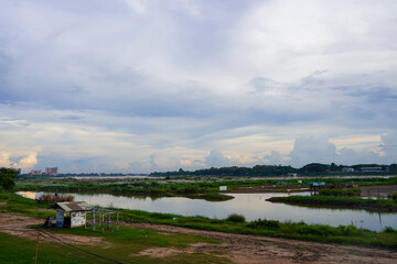 Small hut by the Mekong River under cloudy sky, Vientiane, Laos