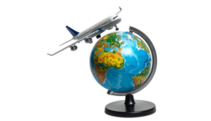 Small airplane model flying above miniature world globe isolated on transparent background.
