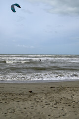 Kitesurfing at italian beach. Some kitesurfers at Torre del Lago beach, tuscany, italy. Some are junping out of the water. Mediterraenean Sea.