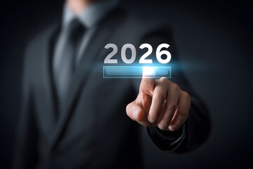 A person touches the year 2026 displayed on a digital screen.