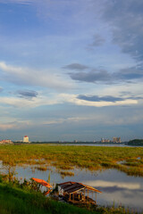 Rustic river huts and flooded grassland along the Mekong River, Vientiane, Laos