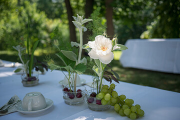 Outdoor Table Setting with Flowers in Summer Light