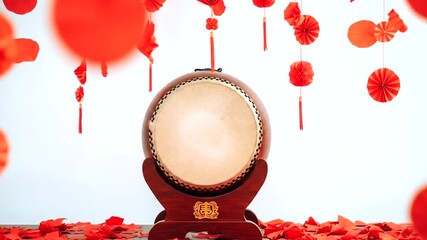 A traditional drum displayed prominently amidst vibrant red decorations for a festive celebration