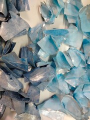 Blue and light-blue wafer paper decorations for cake design. Delicate edible toppers arranged on a clean background.