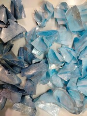 Blue and light-blue wafer paper decorations for cake design. Delicate edible toppers arranged on a clean background.