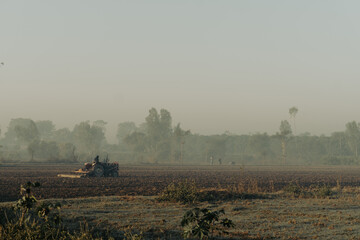 Naklejka premium Tractor plowing rural field agriculture farm landscape farming machinery cultivation soil land work day