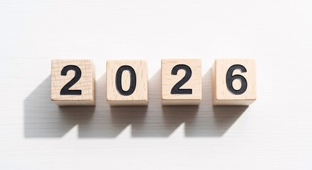 Wooden blocks with the number 2026 representing the new year, future planning, and setting goals on a clean white background