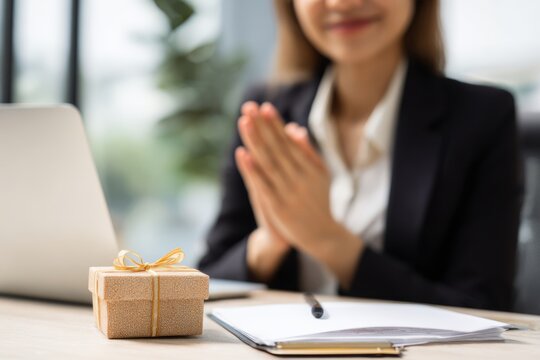 A polite businesswoman gives a small bow, showing gratitude and respect in a professional manner.