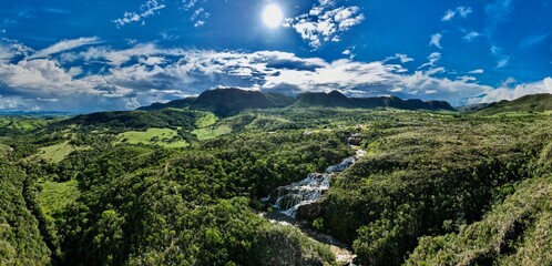 Lush green hillside landscape with rocky terrain