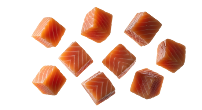 Cubed salmon pieces scattered on transparent background