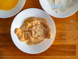Cooking breaded chicken - breading cutlet. Top view