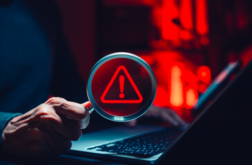 Cyber threat detection and data risk warning concept. Person holding magnifying glass with digital...