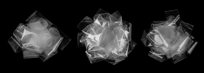 piles of transparent adhesive tape on a black background. Clear tape pieces with visible fingerprints, reflections, and dust form layered sculptural shapes.