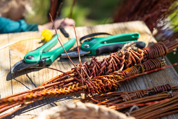 Weaving willow branches with tools for traditional craft © Richard Semik