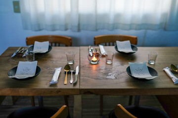 Natural light shines on a cozy dining table prepared 