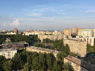 Obraz premium Aerial view of Ufa city with residential buildings and green trees. Urban development, environment, and modern Russian architecture.