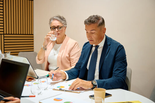 Business colleagues analyzing data and discussing financial report