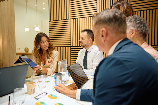 Business team discussing marketing strategy during meeting - Powered by Adobe