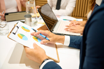 Business professionals analyzing financial data during meeting