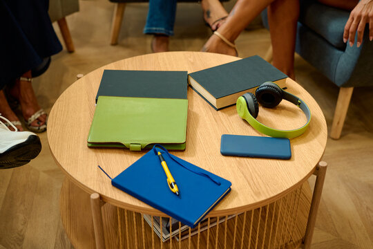 People meeting casually around coffee table with books