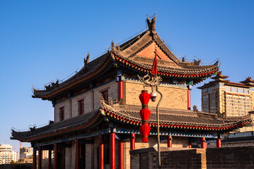 Traditional building and red lanterns on old wall in Xian, China