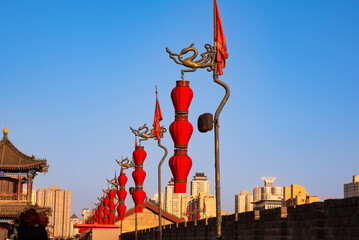 Old wall in Xian, China with traditional towers and red lanterns
