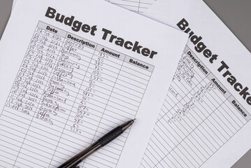 Open daily planner notebook on desk, with neatly handwritten organized Monthly Budget tracking table. With dates, categories and expenses. Personal finance management, spending and budgeting habits 