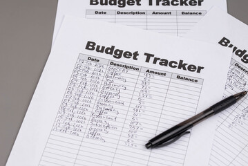 Open daily planner notebook on desk, with neatly handwritten organized Monthly Budget tracking table. With dates, categories and expenses. Personal finance management, spending and budgeting habits 
